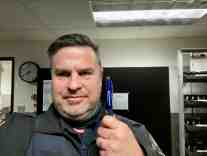 Chaplain Steve with a Light Pen reading "Jesus Backs the Blue"