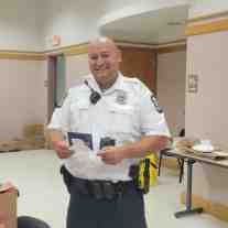 A Columbus PD officer with the hand written thank you card given by Morale Boosters.
