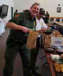 A happy USBP agent picking his sandwich and cookies during the Thank You lunch provided for the El Paso USBP Sector.