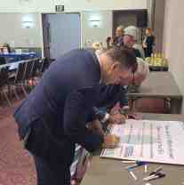 Signing a banner supporting ICE