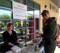 Diane Langan, of Morale Boosters, is serving a USBP Agent at the El Centro Sector Headquarters. Morale Boosters put on a Carne Asada BBQ for the three stations of the El Centro Sector. The boost was the first large boost for the USBP that Morale Boosters put on. The boost included Bibles, Thank You notes, and warm interactions between the agents and volunteers.