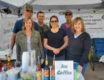 The Coffee Bar, and Snow-Cone station with volunteers from Morale Boosters.  President Tom Langan, Quality Control Officer, Diane Langan, Mike and Crystal Hagan, Jerry Karch, all from Morale Boosters, are standing with Agent Trish from ICE.