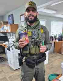 Happily displaying a Peacemaker Bible and light-pen